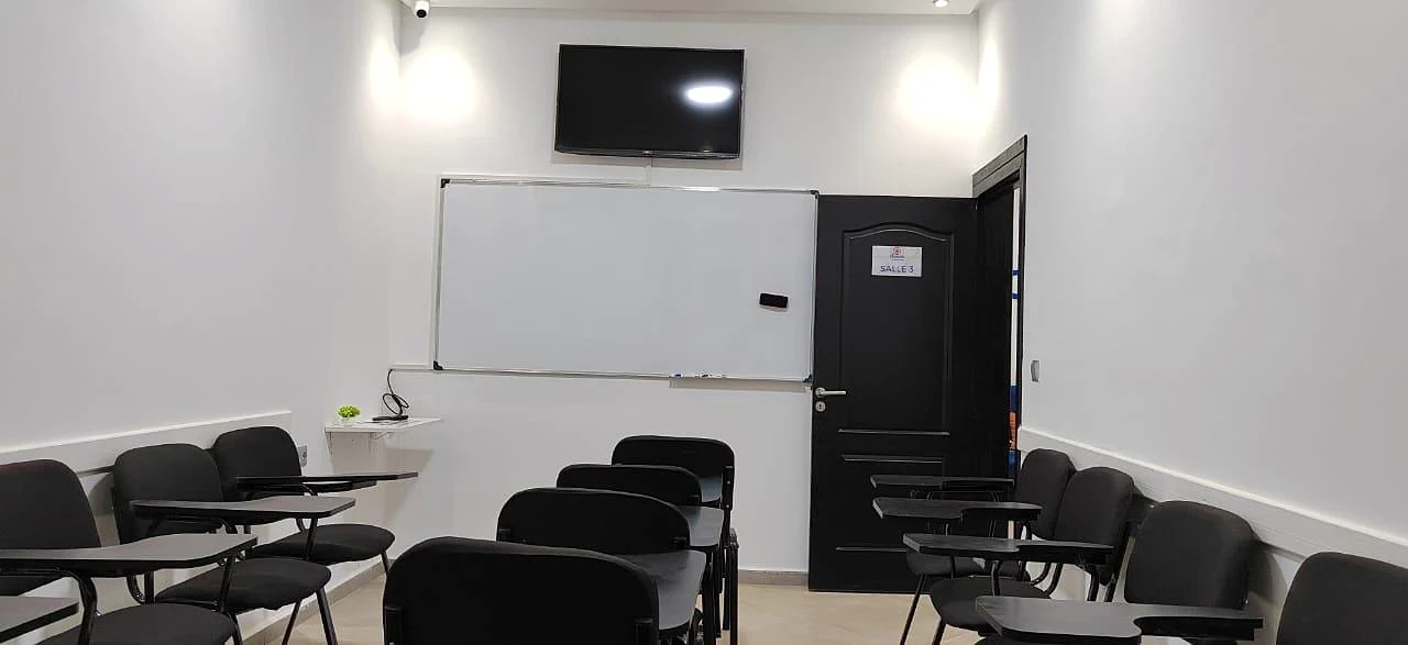 Une salle du centre, avec un tableau blanc et un écran.